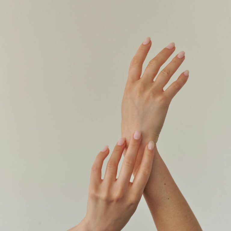 Close-up of a woman's hands elegantly posed, symbolizing elegance and grace.